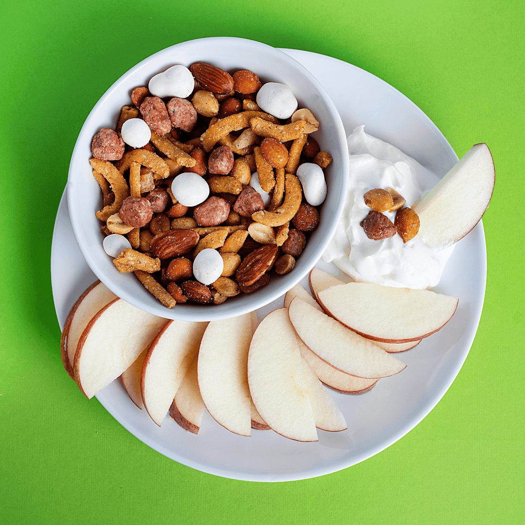 Yogurt Apple Nut Mix 1.5 oz with yogurt and apple slices on a plate